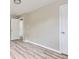 Neutral bedroom features wood-look flooring and two access doors at 4624 W Virginia Ave, Denver, CO 80219