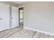 Bedroom view showcasing stylish, light gray floors and an open doorway at 4624 W Virginia Ave, Denver, CO 80219