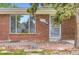 Detailed view of the front entrance of a brick home with a large window for natural light at 4624 W Virginia Ave, Denver, CO 80219