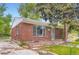 Well-maintained brick house featuring a large picture window and a welcoming front entrance at 4624 W Virginia Ave, Denver, CO 80219