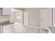 Newly renovated kitchen with open floor plan, white cabinets, and wood-look floors at 4624 W Virginia Ave, Denver, CO 80219