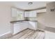 Updated kitchen with white cabinetry, modern countertop, and new sink fixtures at 4624 W Virginia Ave, Denver, CO 80219