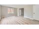 Spacious living room featuring modern flooring, neutral wall paint, and a doorway view to the kitchen at 4624 W Virginia Ave, Denver, CO 80219