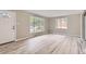 Bright living room with new vinyl floors, neutral paint, and large windows overlooking the front yard at 4624 W Virginia Ave, Denver, CO 80219