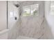 Walk-in shower features rainfall shower head and tiled walls at 4624 W Virginia Ave, Denver, CO 80219