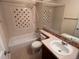 Well-lit bathroom with a bathtub, shower, decorative tiles, and a vanity sink at 10451 Truckee St # 2D, Commerce City, CO 80022