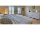 Bright bedroom with two windows, a white dresser and comfortable bedding at 10451 Truckee St # 2D, Commerce City, CO 80022