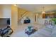 Cozy living room featuring a staircase, view of the kitchen, and comfortable furnishings at 10451 Truckee St # 2D, Commerce City, CO 80022