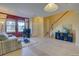 Inviting living room with a comfortable sofa, large windows, and a staircase leading to the upper level at 10451 Truckee St # 2D, Commerce City, CO 80022