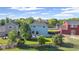 Aerial view of a home with fenced yard and a patio surrounded by mature trees in a neighborhood at 7977 Emerson Ave, Frederick, CO 80530