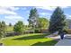Expansive backyard featuring lush lawn, mature trees, and unobstructed views of the green space at 7977 Emerson Ave, Frederick, CO 80530