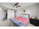 Charming bedroom with barn doors, ceiling fan, and bedside table at 7977 Emerson Ave, Frederick, CO 80530