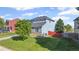 Well-maintained home with a lush green lawn, healthy trees, and colorful exterior at 7977 Emerson Ave, Frederick, CO 80530