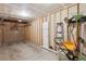 Spacious garage with unfinished walls, a rolling door and various yard tools at 7977 Emerson Ave, Frederick, CO 80530
