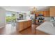 Bright kitchen with wooden cabinetry, stainless steel appliances, and sliding doors to the backyard at 7977 Emerson Ave, Frederick, CO 80530