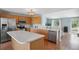 Well-lit kitchen features wooden cabinetry, stainless steel appliances, and an island for additional space at 7977 Emerson Ave, Frederick, CO 80530