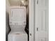 This laundry area features a stacked washer and dryer at 7977 Emerson Ave, Frederick, CO 80530