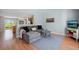 Comfortable living room featuring a gray sectional, light blue walls, and wood laminate flooring at 7977 Emerson Ave, Frederick, CO 80530