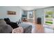 Inviting living room featuring a gray sectional, a large window, and light blue walls at 7977 Emerson Ave, Frederick, CO 80530