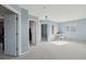 Open loft area with carpet, neutral paint, and multiple doorways at 7977 Emerson Ave, Frederick, CO 80530
