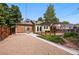Rear view of property with gravel driveway and wooden pergola at 3321 Stuart St, Denver, CO 80212