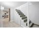 Staircase to basement with painted stairs and tile flooring, plus storage and laundry at 3321 Stuart St, Denver, CO 80212