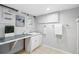 Basement bathroom with tiled floor and sink with open plumbing at 3321 Stuart St, Denver, CO 80212