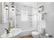 Bright, clean bathroom with shower-tub combo, white tile, and modern fixtures at 3321 Stuart St, Denver, CO 80212