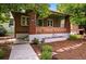 Charming brick home showcasing a welcoming front porch and beautifully landscaped yard at 3321 Stuart St, Denver, CO 80212