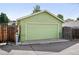 View of detached one-car garage with green siding and a traditional door at 3321 Stuart St, Denver, CO 80212