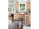 Open kitchen features tile backsplash, floating shelves, island and natural light at 3321 Stuart St, Denver, CO 80212