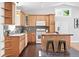 Spacious kitchen featuring tiled backsplash, modern appliances and eat in island with stools at 3321 Stuart St, Denver, CO 80212