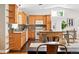Bright kitchen featuring wood cabinets, a mosaic backsplash, a kitchen island and stainless steel appliances at 3321 Stuart St, Denver, CO 80212