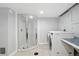 Finished basement laundry room with glass enclosed shower and washing machine at 3321 Stuart St, Denver, CO 80212