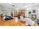 Bright open-concept living and dining area with hardwood floors and a well-equipped kitchen at 3321 Stuart St, Denver, CO 80212