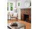 Close-up of brick fireplace, hardwood flooring, and stylish furniture in the living room at 3321 Stuart St, Denver, CO 80212
