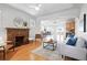 Inviting living room with hardwood floors, a brick fireplace, and an open concept design at 3321 Stuart St, Denver, CO 80212