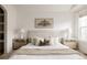 Cozy bedroom with matching nightstands, soft bedding, and a calming tree print above the bed at 9852 E Idaho St, Aurora, CO 80247