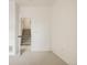 Bright bedroom with white walls and neutral carpet, leading to a stairway with natural light at 9852 E Idaho St, Aurora, CO 80247