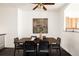 Dining room with modern dark wood table and chairs, with glimpse into the kitchen at 9852 E Idaho St, Aurora, CO 80247