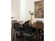 Formal dining room featuring a wooden table, modern black chairs and decor at 9852 E Idaho St, Aurora, CO 80247