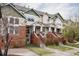 Charming multi-level townhomes with brick accents, front steps, and well-maintained lawns at 9852 E Idaho St, Aurora, CO 80247