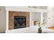 Close-up of the fireplace featuring tiled surround and decorative shelving in the living room at 9852 E Idaho St, Aurora, CO 80247