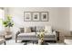 Comfortable living room with stylish sofa, decorative pillows, and a fiddle-leaf fig plant at 9852 E Idaho St, Aurora, CO 80247