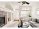 Bright living room with fireplace, plush sofa, and ample natural light from large windows at 9852 E Idaho St, Aurora, CO 80247