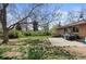 View of the backyard featuring grass, patio, and brick house at 4102 W Eastman Ave, Denver, CO 80236