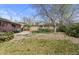 Home's backyard showing mature trees, patio and wooden fence at 4102 W Eastman Ave, Denver, CO 80236