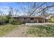 View of a brick home with backyard, patio and solar panels at 4102 W Eastman Ave, Denver, CO 80236