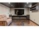 Finished basement featuring a theater space with a large flatscreen TV and a comfortable couch at 4102 W Eastman Ave, Denver, CO 80236