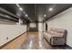 Finished basement featuring a comfortable couch and a entertainment center at 4102 W Eastman Ave, Denver, CO 80236